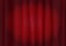 Red velvet stage curtain with spot lighting