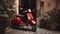 red vespa 50 special parked in an alley in front of a period door and pots with plants.