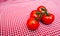 Red Vine tomatoes against red and white chequered cloth