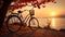 Red vintage bicycle parked by the river at sunset