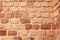 Red vintage brick wall background. Uneven vintage bricks