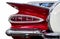 Red vintage car detail with restored chrome plating
