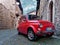 Red vintage city car parked old village