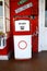 Red vintage gasoline pump over white background