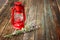 Red vintage kerosene lamp, and lavender flowers on wooden table. fine art concept.