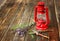 Red vintage kerosene lamp, and sage flowers on wooden table. fine art concept.