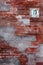 Red vintage stylish brick wall with house number plate