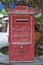 Red Vintage Wooden Mailbox under a Tree