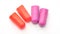 Red and violet earplugs on a white background