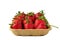 Red vivid ripe strawberries laying in organic brown cardboard pallet box