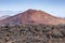 Red volcano near Los Hervideros caves in Lanzarote, Canary Islands.