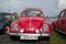 Red Volkswagen Beetle front view. Exhibition and parade of retro cars in Kronstadt