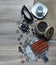 Red wallet with american dollars, various foreign coins, sunglasses and cup of coffee on the table