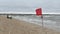 Red warning flag forbidding to swim on the beach