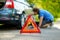 Red warning triangle sign on the road