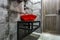 Red washbasin with faucet in expensive loft bathroom in elite sport bar on black brick wall background