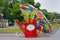 Red watering can with butterfly under umbrella as art installation at the festival `Moscow summer` in Bolotnaya square in Moscow