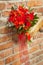 red wedding bouquet on a brick background