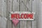 Red welcome sign with red checkered heart