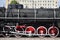 Red wheels of old USSR black steam locomotive. Wheels of an old soviet steam trai