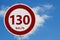 Red and white 130 km speed limit sign