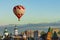 Red and white balloon flies very low over the city, directly over the Christian Church and the Kremlin in the clear cloudless sky