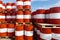 Red-white barrels with oil. Warehousing containers ready for shipment. Refining and selling oil derivatives
