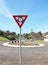 Red, white and black sign indicating a roundabout ahead