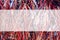 Red white and blue cellophane tinsel strips background with bokeh with semitransparent panel for copy