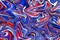 Red, white and blue marbling paint swirls background.