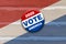 Red white blue vote 2020 america button pin on wood background