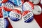 Red, white, and blue vote buttons on background