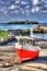 Red and white boat Mullion Cove harbour Cornwall UK in colourful bright HDR