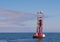 Red and White Buoy In Calm Water