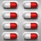 Red and white capsule pills with background