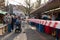 Red and white caution tape restrict people with face protective mask who shopping at outdoor local farmer market .