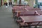 Red and white caution tape wrapped around outdoor tables and seats during epidemic of COVID-19 virus.