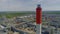 Red white chimney at refinery complex with pipes aerial view