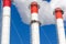 Red-white chimneys of the boiler room, equipped with a traffic light. industrial climbers carry out routine repairs. smoke o