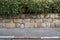 Red and white colored road curbstone indicating the prohibition of Parking on Israel street