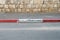 Red and white colored road curbstone indicating the prohibition of Parking on Israel street