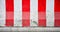 Red and white concrete barriers blocking the road - closeup