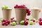 Red and white currants, green gooseberries in cardboard cups
