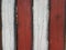 Red and white fence with black streaks