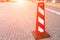 Red and white flat parking bollard on the road near the apartment