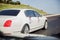 Red and white flowers bouquet . Closeup image of wedding car decoration . Wedding decorations on the hood of the car. Road .