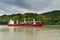 Red and white freighter container ship traveling along the Seine River from Paris to the English Channel