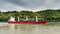 Red and white freighter container ship traveling along the Seine River from Paris to the English Channel