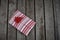 A red and white gift on wood slats