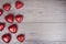 Red and white glitter hearts on wooden background